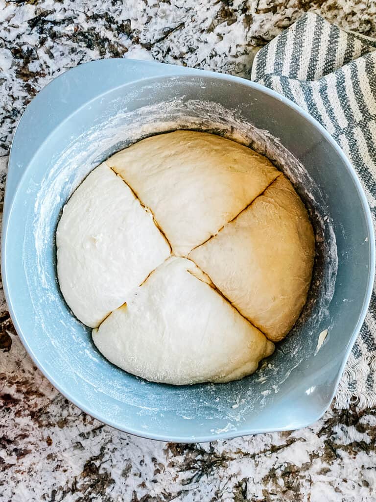 The risen dough split into 4 equal parts.