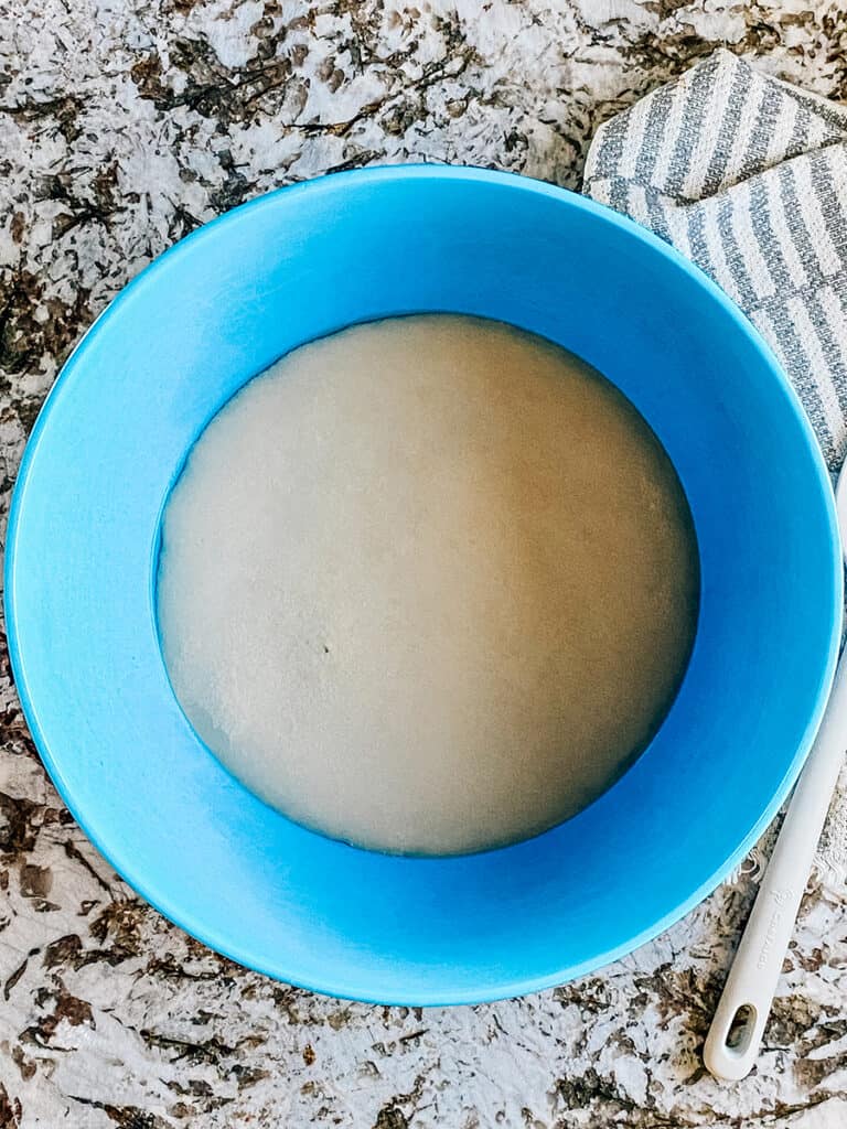 Proofed yeast in the large mixing bowl.