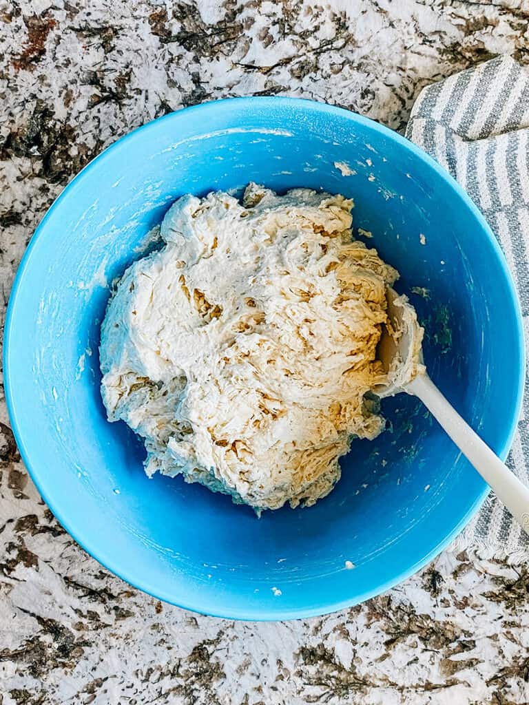 Mixed sticky dough in a large bowl.