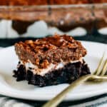 Plated loaded brownies with a layer of fudge brownies, melted marshmallows, and crispy chocolate and peanut butter topping.