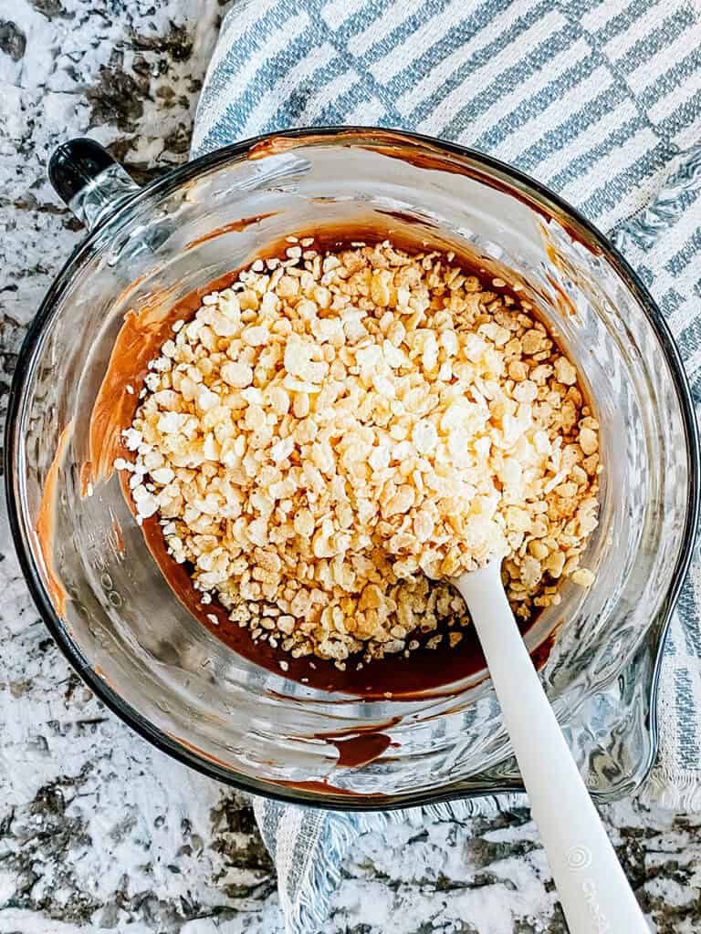 Crispy rice added to the melted chocolate and peanut butter.