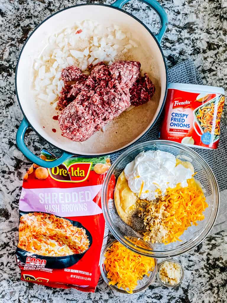 Cheesy ground beef and has brown casserole ingredients on the counter.