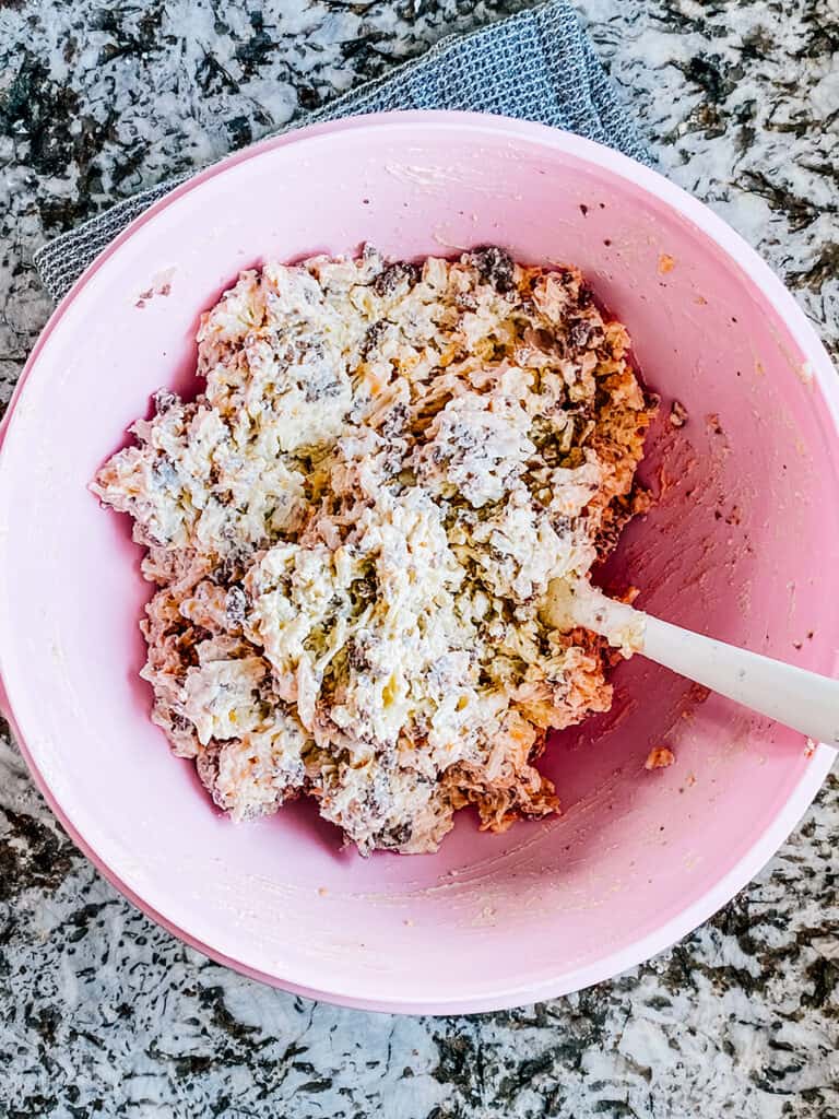 Mixed browned ground beef and creamy hash browns ready to place into a baking dish.
