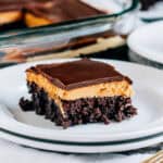 A completely cool and delicious buckey brownies with decadent layers of fudge brownie, peanut butter filling, and chocolate topping.