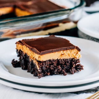 A completely cool and delicious buckey brownies with decadent layers of fudge brownie, peanut butter filling, and chocolate topping.