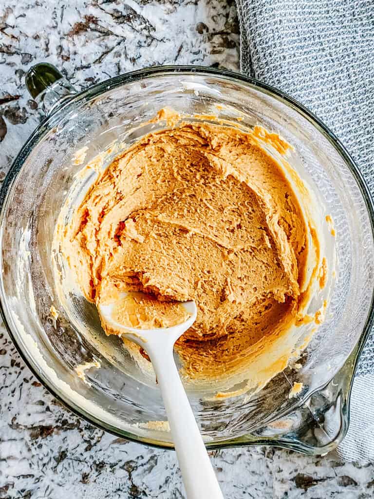 The mixed peanut butter layer in a glass bowl.