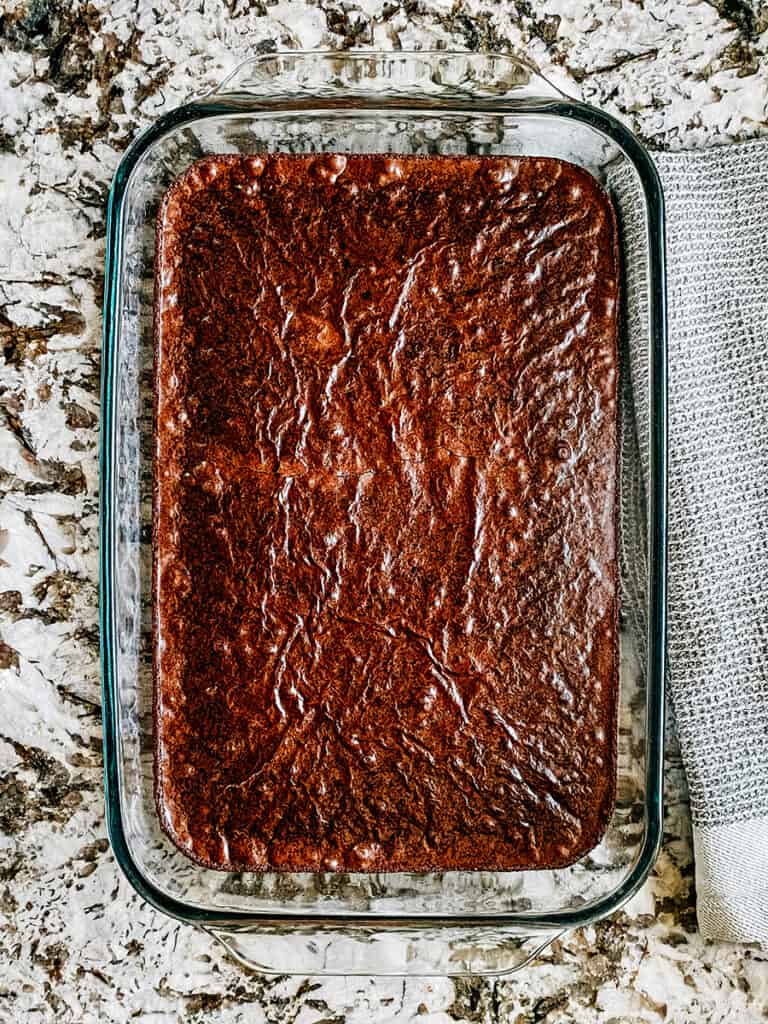 A pan of box brownies baked and ready to be made in the best layered dessert brownies: buckeye brownies.