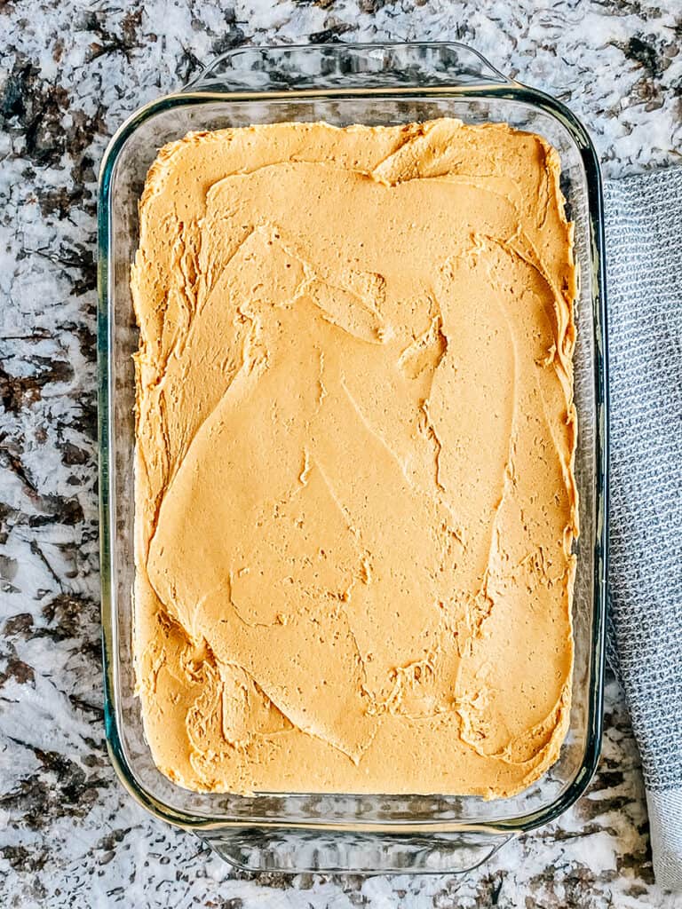 The peanut butter filling spread evenly out on the brownies.
