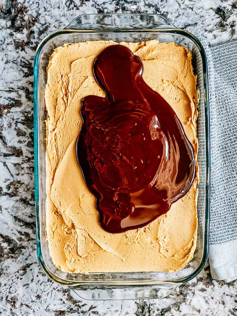 The chocolate sauce pour onto the peanut butter filling layer.