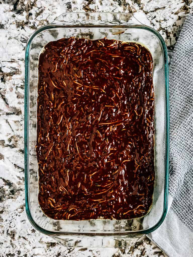 The zucchini brownie batter spread into a 9x13-inch baking dish.