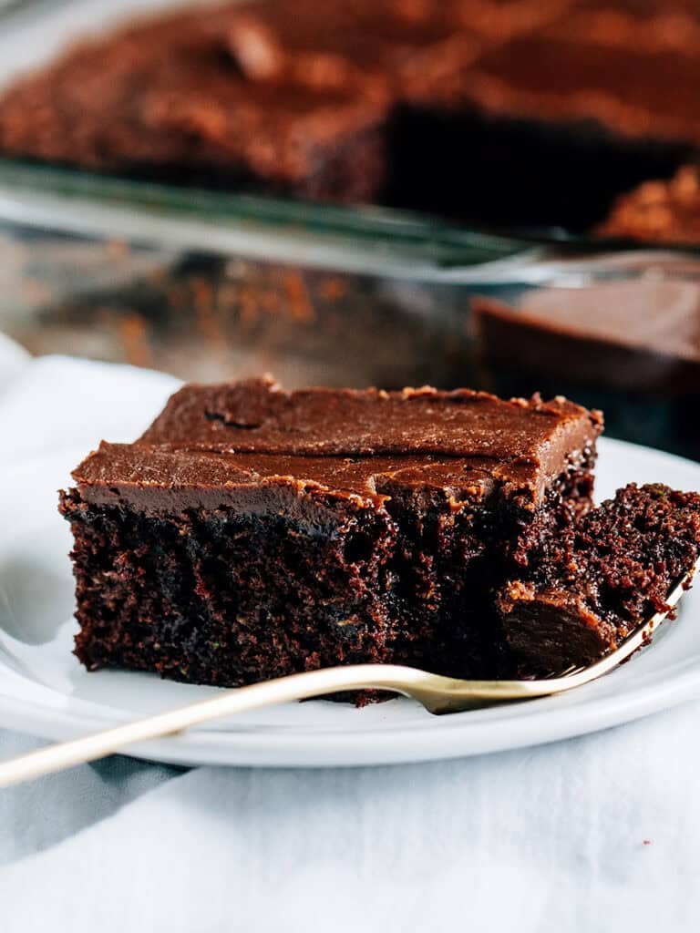Plated zucchini brownies topped with a one-minute frosting for the BEST frosted zucchini brownies.