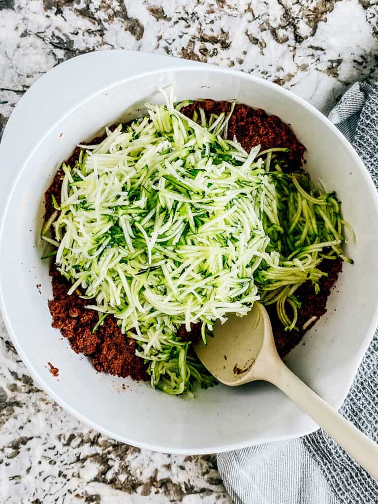 Shredded zucchini on top of the crumbled batter.